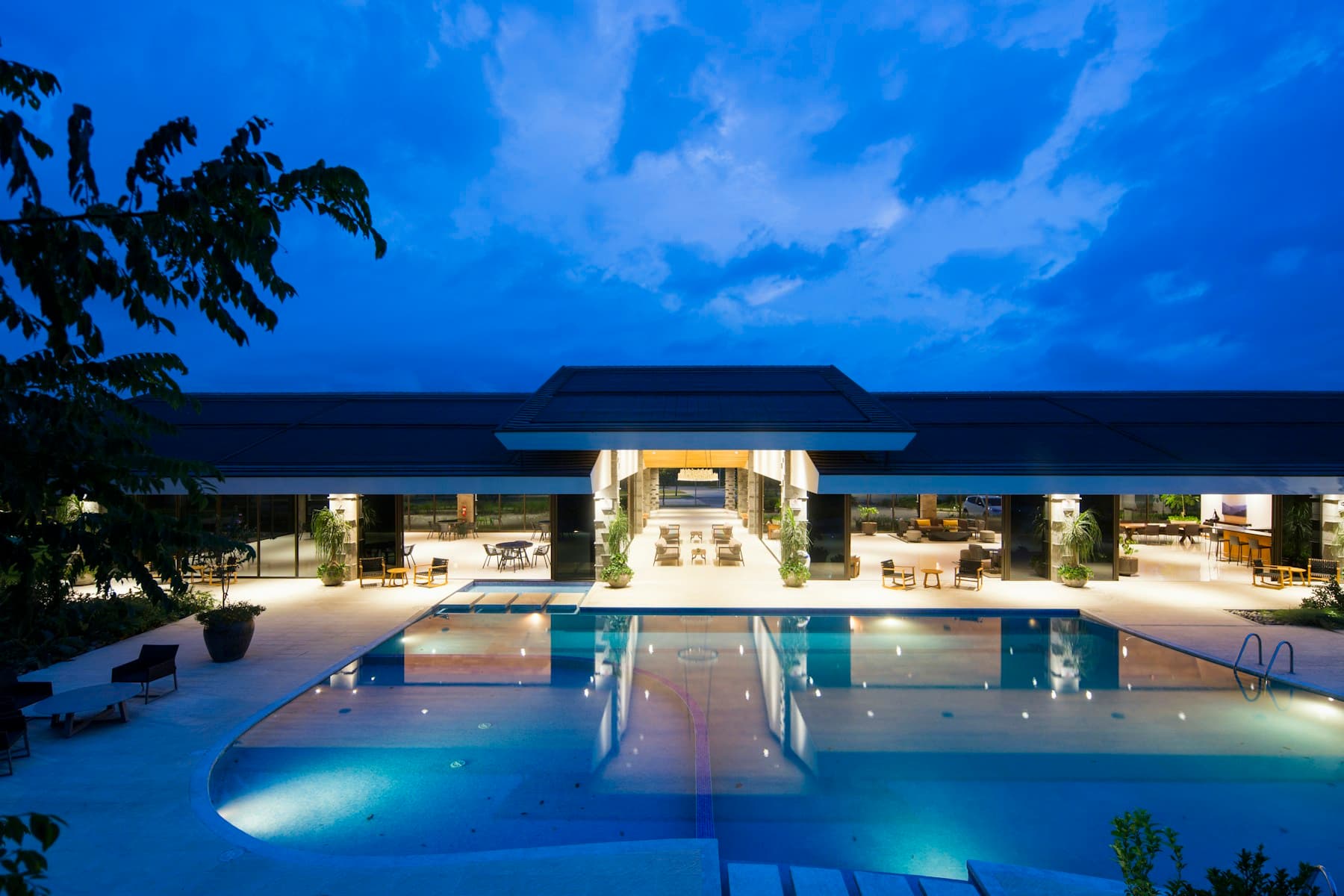 Luxury villa with evening pool lighting for private staffing and daily villa care